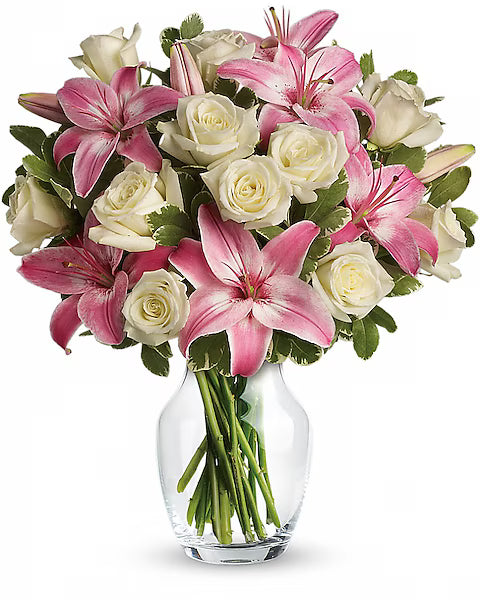Bouquet of pink and white flowers in a clear vase