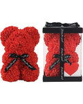 Red rose teddy bear and packaging with a heart and ribbon 