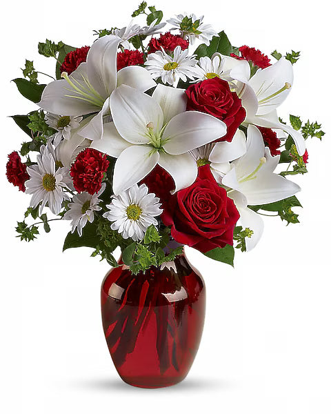 Bouquet of red and white flowers in a vase 