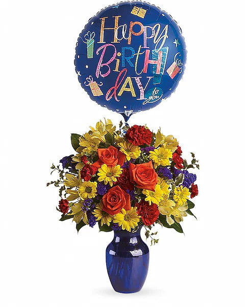 Colorful bouquet of flowers in a \vase with a 'Happy Birthday' balloon