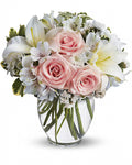 Bouquet of pink roses and white lilies in a vase